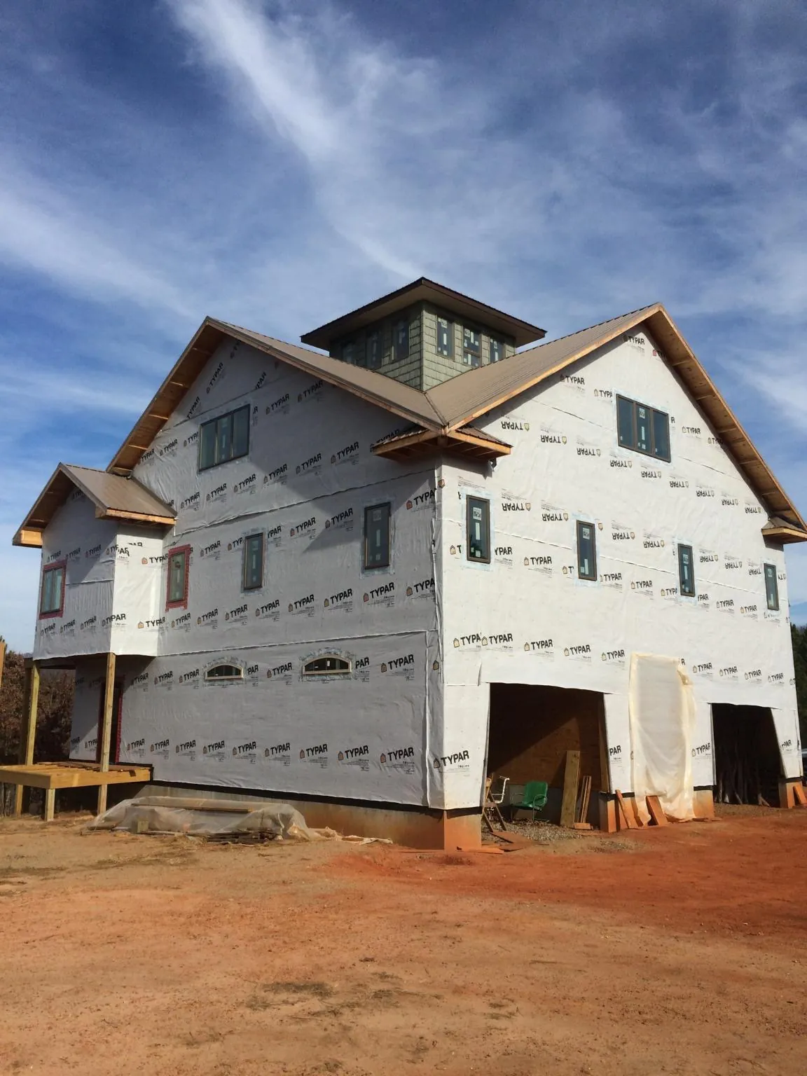 New two story house under construction with a cupola and gabled roofs in Stratford